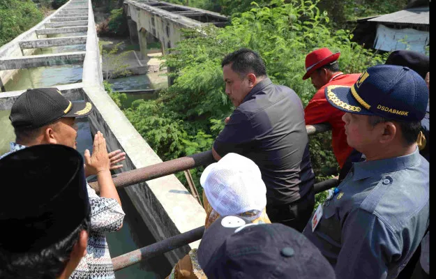 Pj Bupati Bekasi, Dedy Supriadi bersama unsur Forkopimda meninjau aliran sungai hadapi kekeringan di lahan pertanian. (Dok. Diskominfo Kabupaten Bekasi)