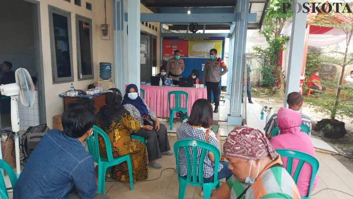 Kapolsek Beji Kompol Agus Khaeron bersama anggota menjalankan kegiatan vaksin lansia di Kampung Tangguh Jaya RW.05 Beji. (foto: angga)