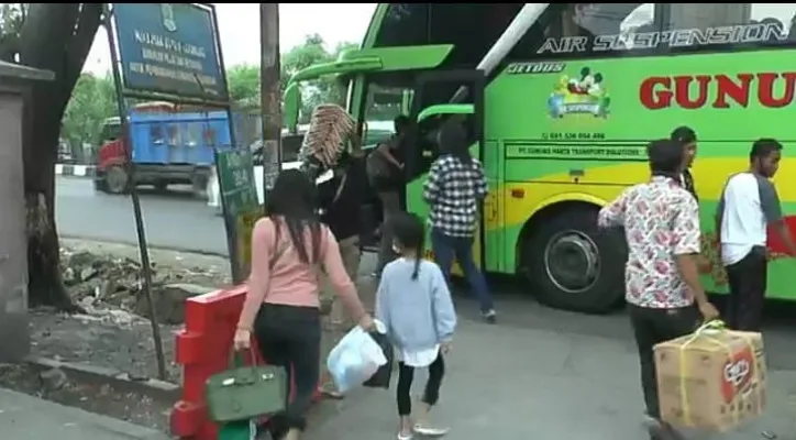 Pemudik menaiki bus di luar Terminal Karawang. (foto: ist)