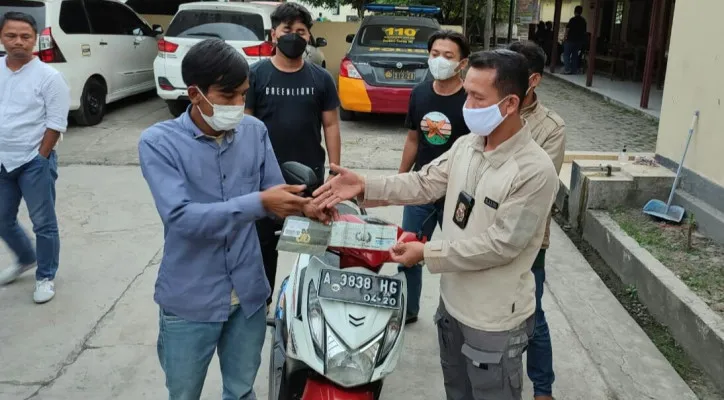 Tim Reskrim Polsek Ciruas menyerahkan motor hasil rampasan debt collector kepada Enong. (foto: ist)