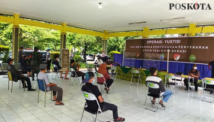 Terjaring operasi yustisi, pelanggar kebijakan PPKM Darurat melakukan sidang di Kantor Kecamatan Bekasi Selatan, Kamis (8/7/2021) (Foto/Poskota.co.id/cr02)