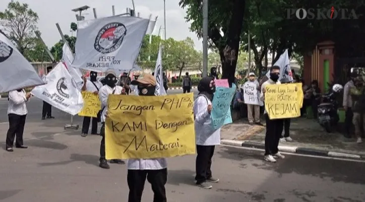 Puluhan massa dari FPHI Kota Bekasi Lakukan unjuk rasa menagih janji Wali Kota Bekasi untuk dijadikan status honorer menjadi PNS, di Pintu Gerbang Gedung Pemkot Bekasi. Kamis (28/10/2021) pagi. (Poskota/Ihsan Fahmi)