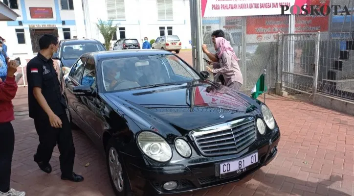 Mobil sedan berwarna hitam dengan bendera Nigeria keluar dari halaman Kantor Rudenim Jakarta. (foto: poskota/cr01)