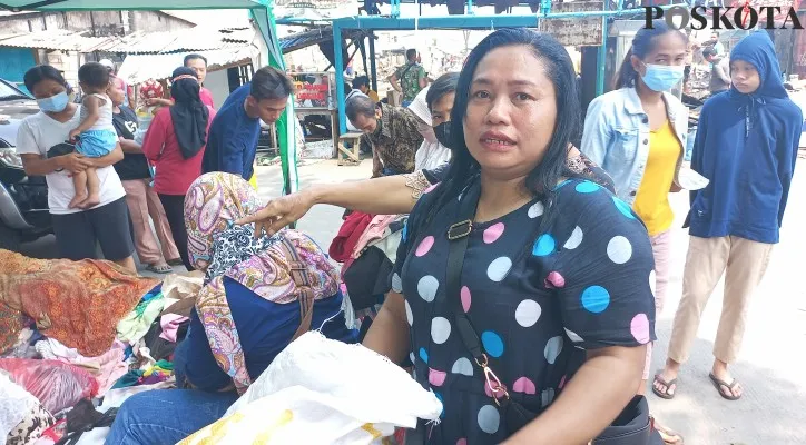 Indah (36) salah satu korban kebakaran saat mencari baju ganti yang diberikan warga. (Pandi)