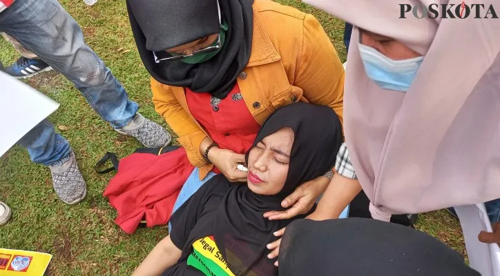 Perempuan cantik ditemukan tergeletak tak berdaya di tengah aksi unjukrasa di gedung DPR. (foto: poskota/pandi)