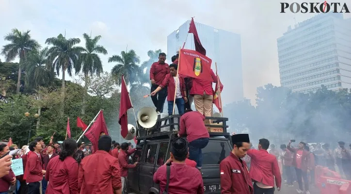 Kelompok mahasiswa IMM menyalakan suar hingga membuat kepulan asap di sekitaran area Patung Kuda Arjuna Wiwaha, Jakarta Pusat saat unjuk rasa tolak kenaikan BBM. (foto: poskota/adam)