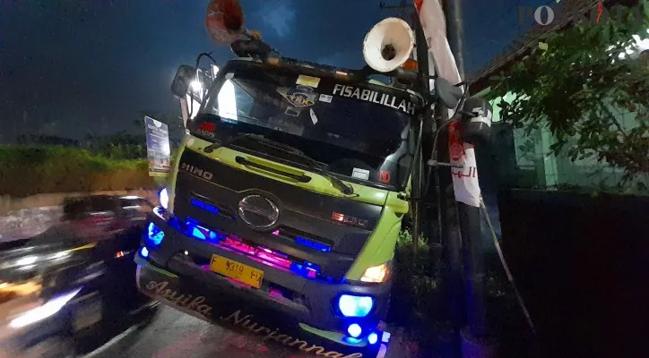 Truk terperosok masuk gorong-gorong.(Foto: Panca)