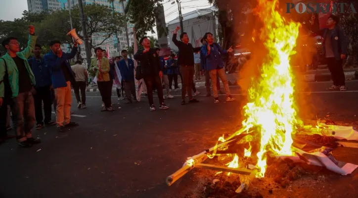 Mahasiswa yang tergabung dalam Badan Eksekutif Mahasiswa Seluruh Indonesia (BEM SI) saat melakukan aksi bakar spanduk di Patung Kuda Arjuna Wijaya, Medan Merdeka Barat, Jakarta Pusat, Selasa (30/7/2024). Dalam aksinya tersebut mereka menolak rencana revisi UU TNI dan Polri untuk selamatkan demokrasi dan nilai-nilai reformasi yang berada pada rezim otoriter Presiden Joko Widodo.Poskota/Ahmad Tri Hawaari