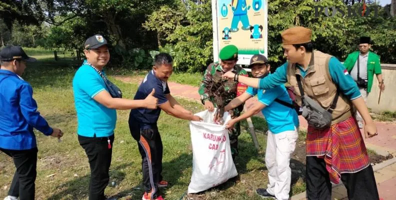 Warga bersama anggota Koramil 13 Cisoka bergotong royong membersihkan sampah-sampah di lingkungan makam keramat Solear, Jumat (21/5/2021). (ridsha vimanda)