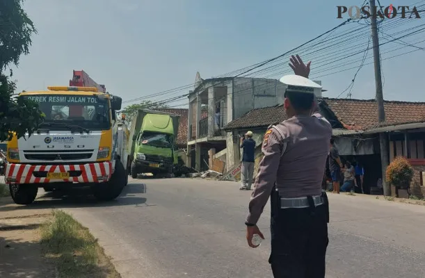 Proses evakuasi truk boks yang menabrak rumah dan kendaraan roda dua di Jalan Raya Maja- Solear, Kecamatan Solear, Tangerang, pada Jumat, 16 Agustus 2024. (Poskota/Veronica Prasetio)