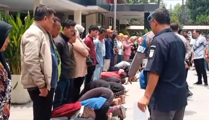 Puluhan remaja dihukum sujud di bawah kaki orang tua setelah diamankan polisi karena hendak tawuran di Cikarang. (Poskota/Ihsan)