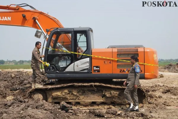 Anggota Satpol PP Kabupaten Tangerang saat menyegel alat berat di lokasi galian tanah. (Poskota.co.id/Veronica Prasetio)