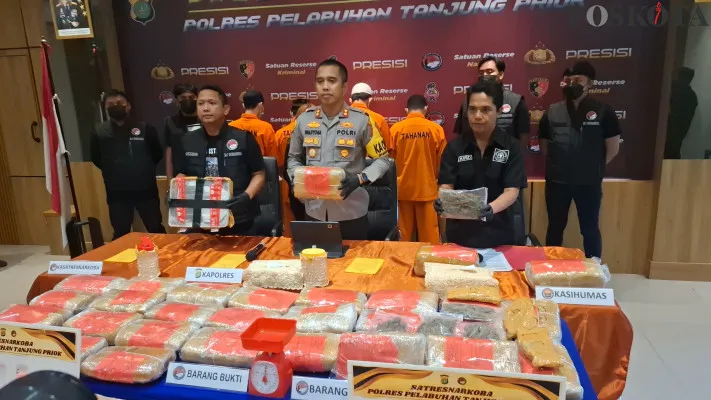 Anggota Polres Pelabuhan Tanjung Priok menunjukkan barang bukti berupa puluhan kilogram ganja dan raturan butir ekstasi di Polres Pelabuhan Tanjung Priok pada Selasa, 3 Desember 2024. (Poskota/Angga Pahlevi)