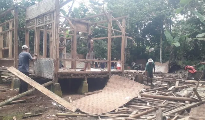 Warga Saketi dan pemilik rumah saat membenahi bangunan rumah yang ambruk. (Foto: Ist).