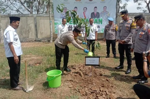 Kapolres Serang AKBP Wiwin Setiawan menyiram usai menanam pohon di halaman Mapolres Serang. (ist)